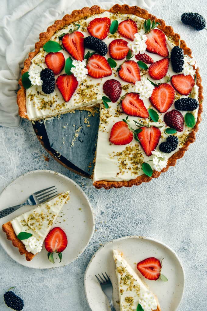 Strawberry pie with homemade cream cheese pie crust and two slices on the side 