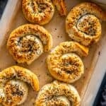 Baking dish with golden spiral potato böreks topped with sesame and nigella seeds, labeled “Potato Borek.”