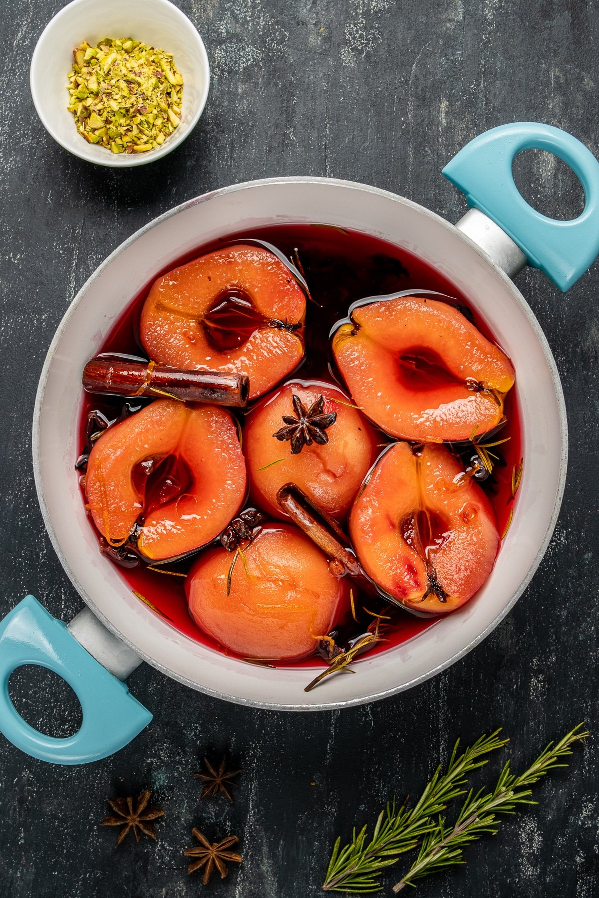 Quinces poached with spices in a pot.