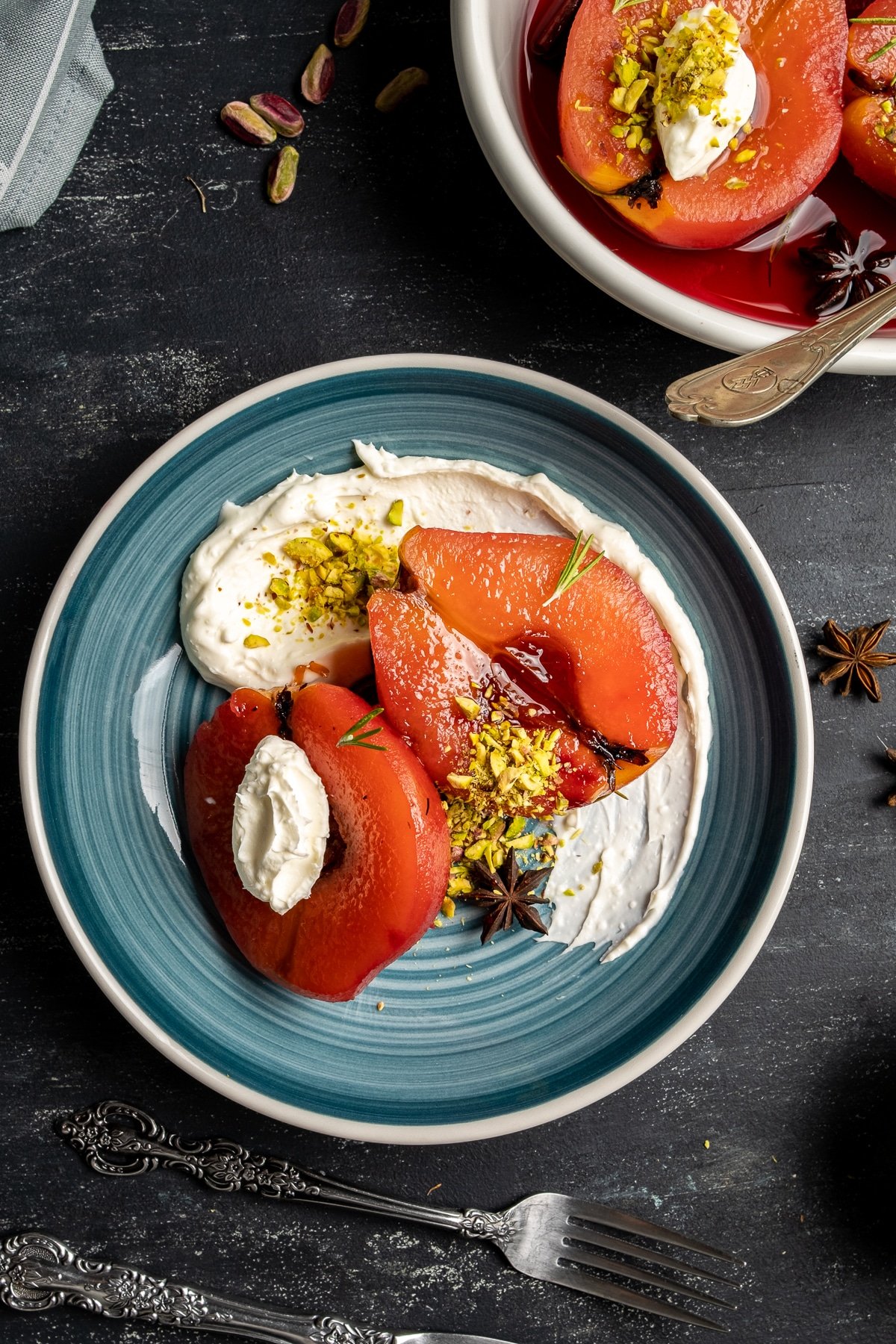 Turkish style quince dessert served with pistachio and clotted cream on a plate.