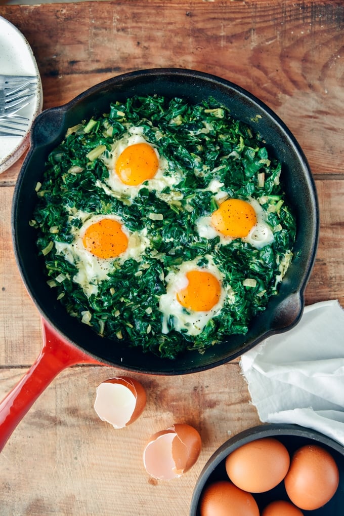 Eggs with spinach in a cast iron skiller