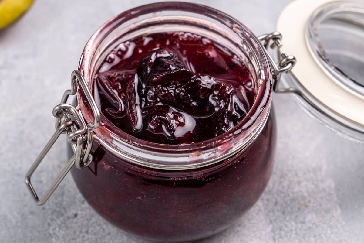 Small batch plum jam in a glass jar.