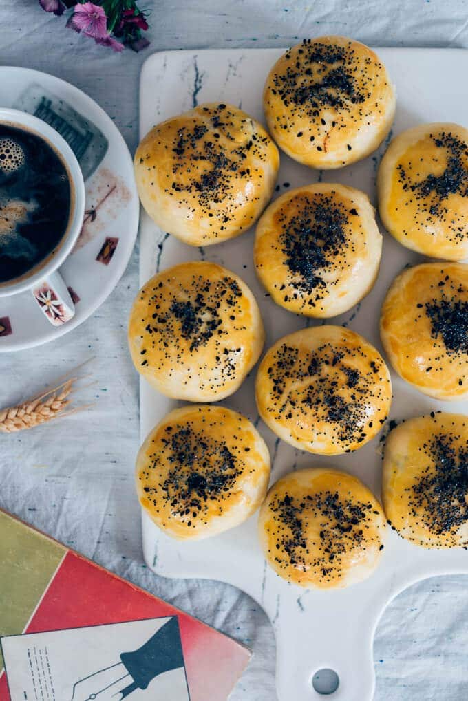 Turkish pogaca rolls on a white board with coffee