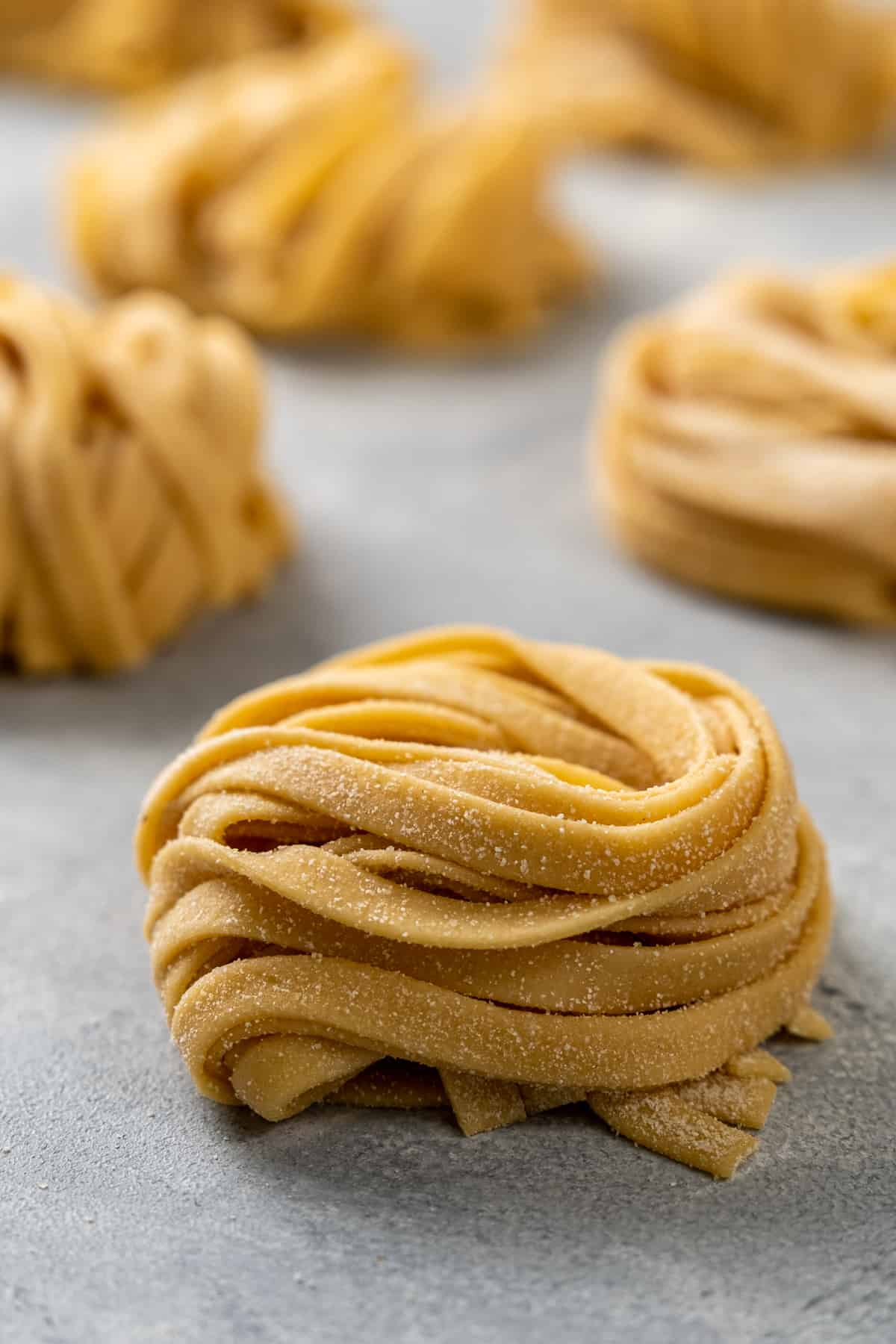 Close shot of nested fresh pasta dough strips.