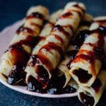 Crepes Filled with Jam can easily turn your breakfast to a feast. Are you saying you are not a breakfast person? Believe me you can’t say ‘no’ to breakfast with these festive looking crepes.