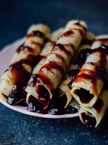 Crepes Filled with Jam can easily turn your breakfast to a feast. Are you saying you are not a breakfast person? Believe me you can’t say ‘no’ to breakfast with these festive looking crepes.