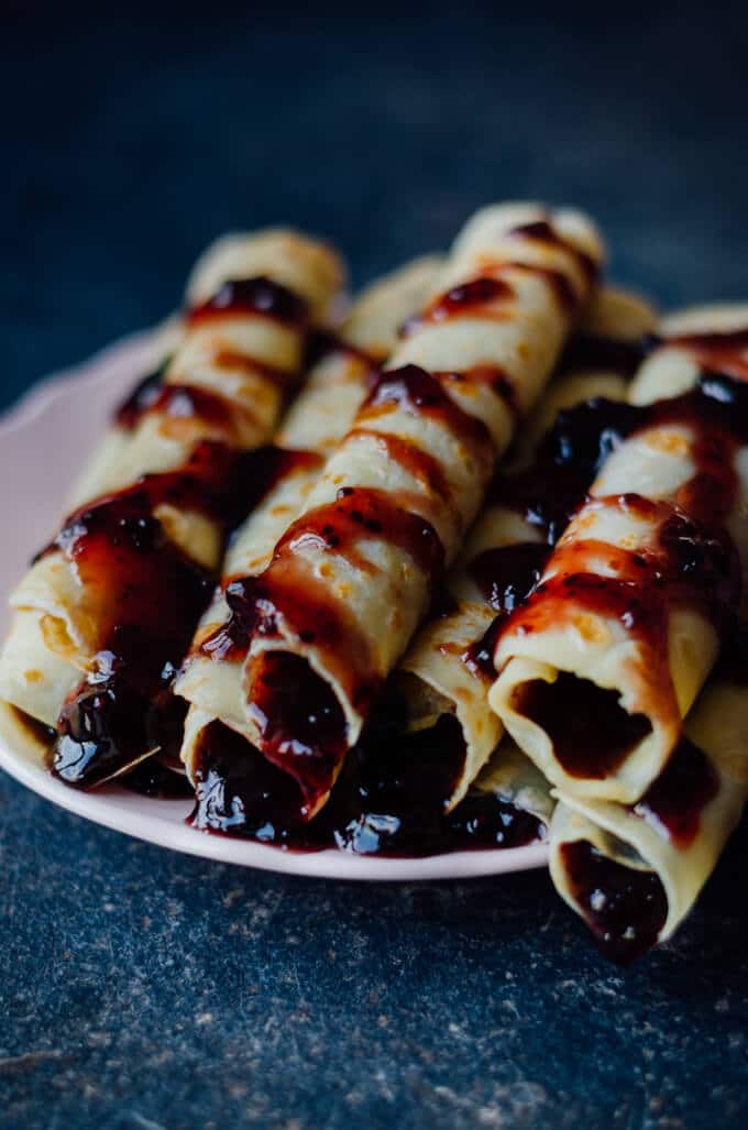 Crepes Filled with Jam can easily turn your breakfast to a feast. Are you saying you are not a breakfast person? Believe me you can’t say ‘no’ to breakfast with these festive looking crepes.