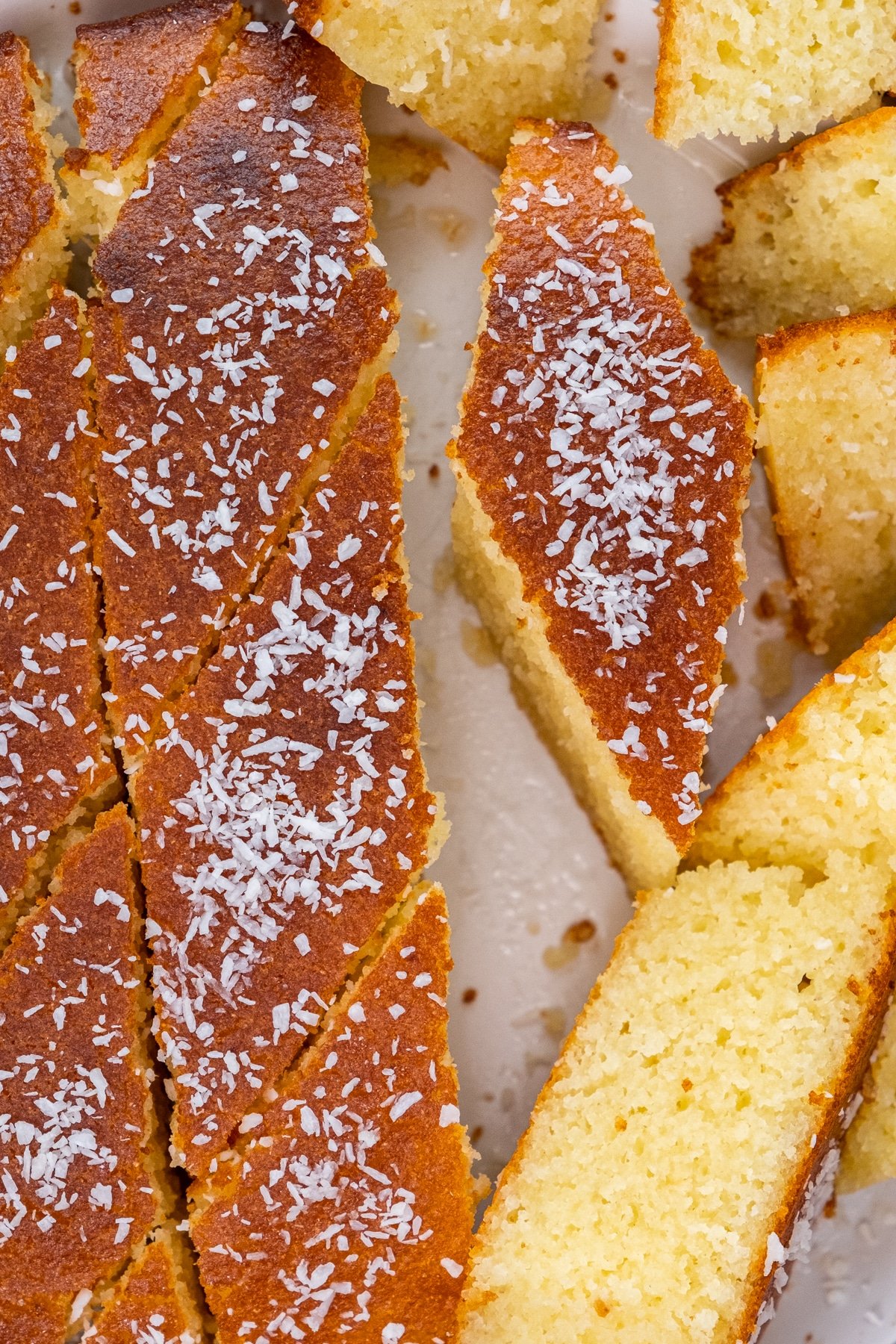 Turkish revani slices on a white plate.