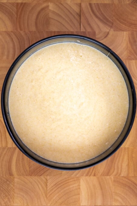 Cake batter in a round baking pan.