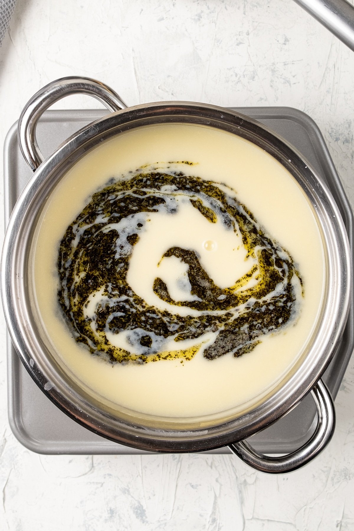 Turkish yayla corbasi topped with a butter mint sauce in a pot.