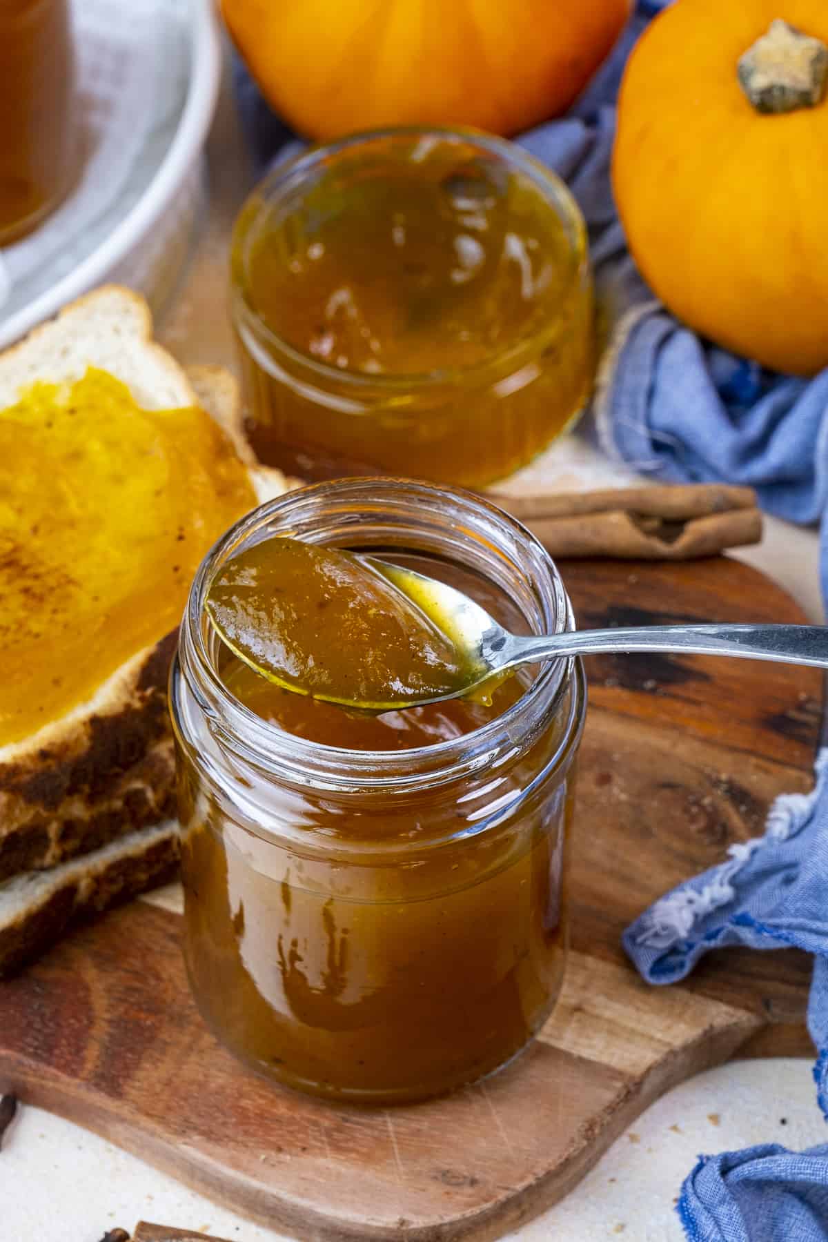 Pumpkin jam in a jar and spoon in it.