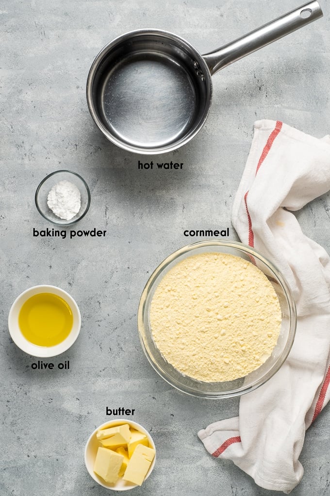 Ingredients for homemade cornbread on a grey background.