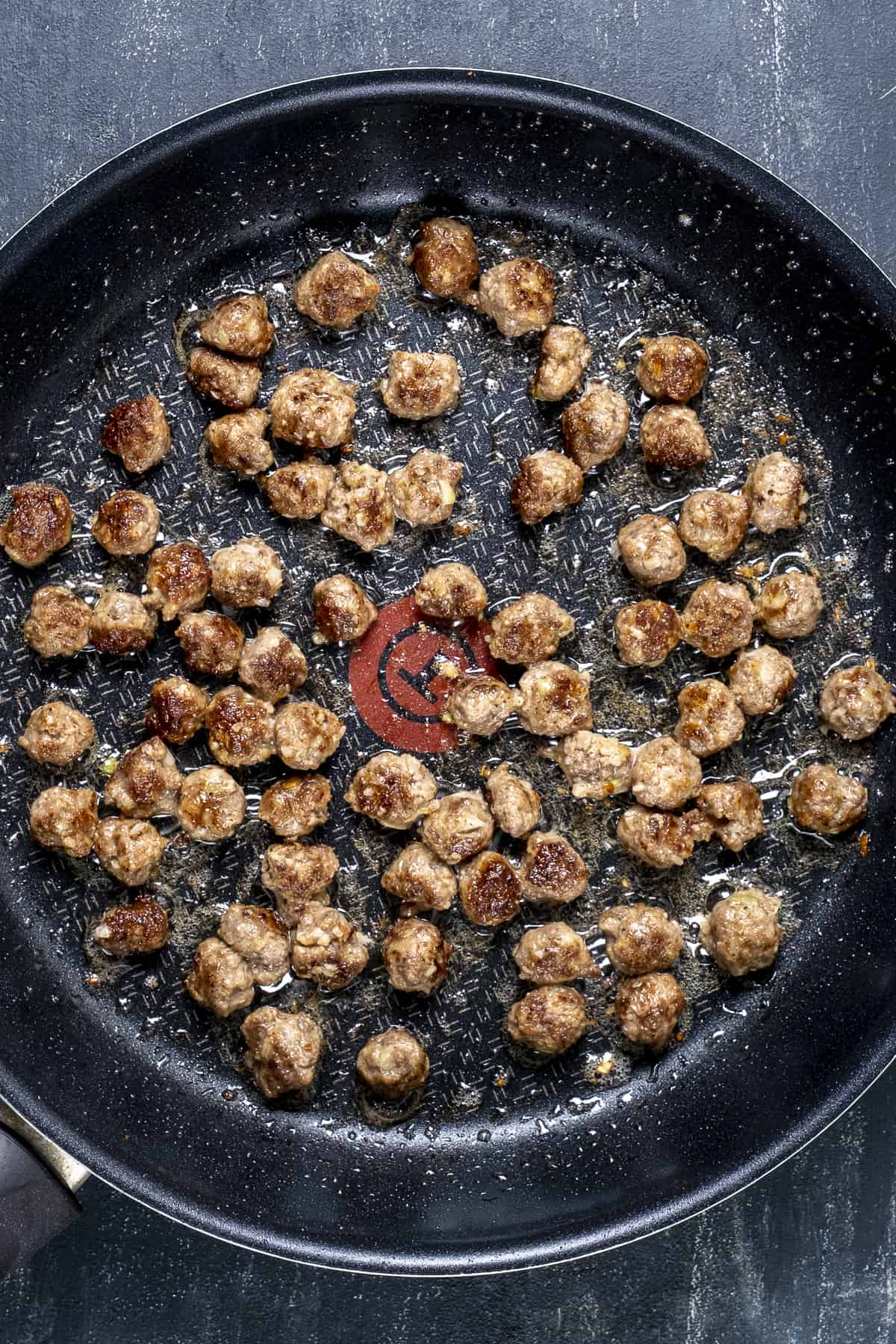 Mini meatballs cooked in a pan.