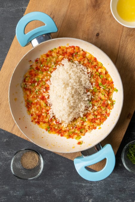 Rice and vegetables in a white pan.