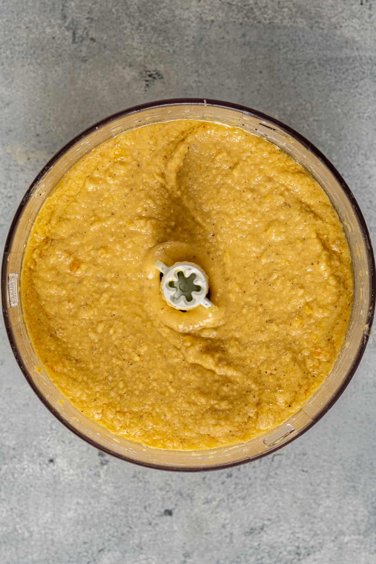 Creamy red lentil hummus in a blender.