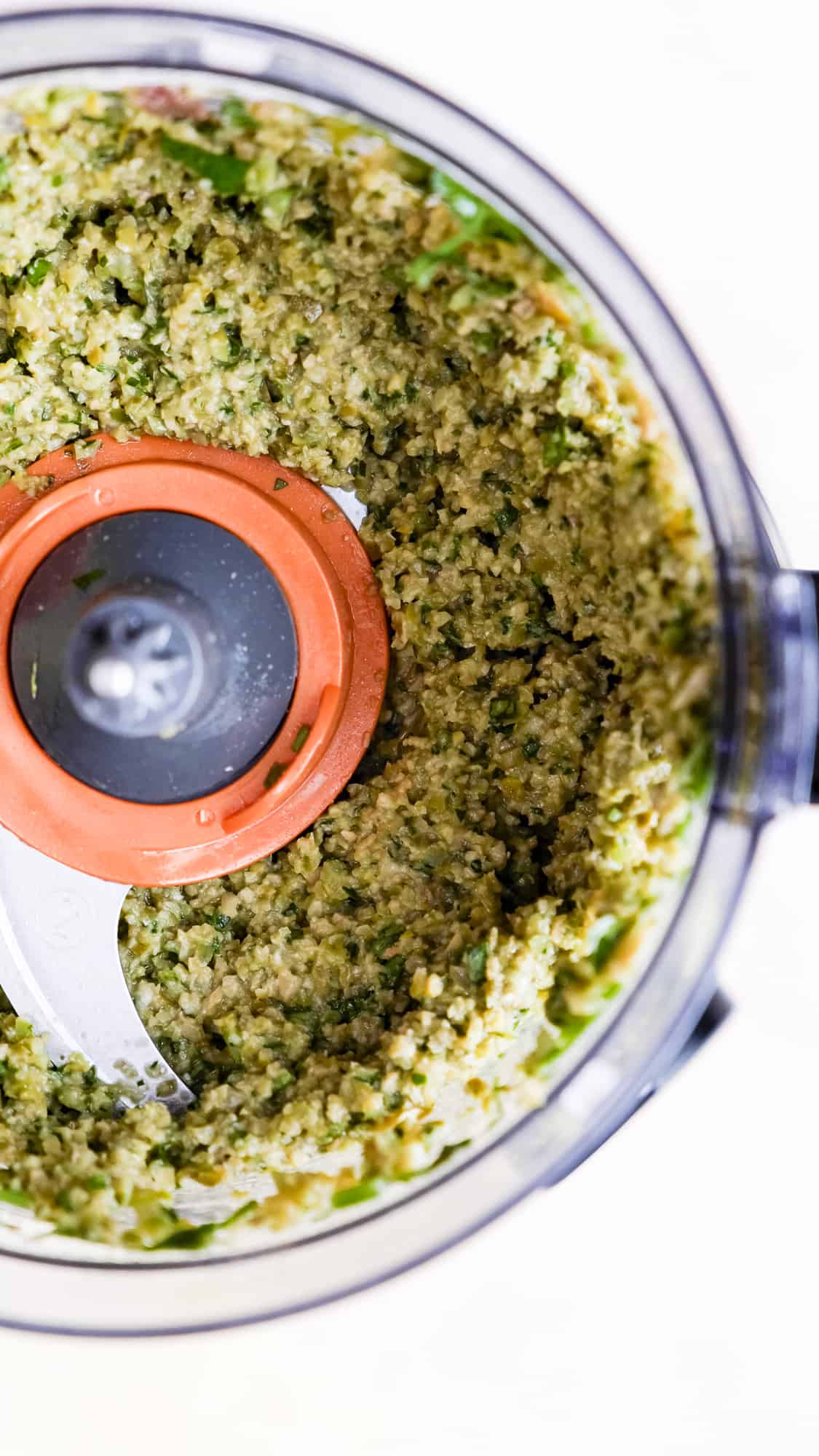 Tapenade ingredients chopped in a food processor.