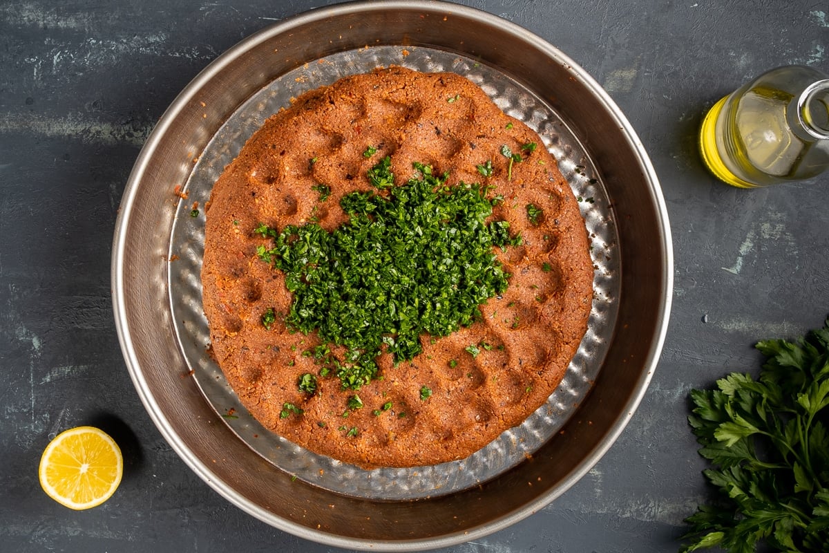 Fine bulgur mixture with parsley in a traditional cig kofte tray.