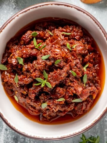 Spicy sun-dried tomato dip in a white bowl