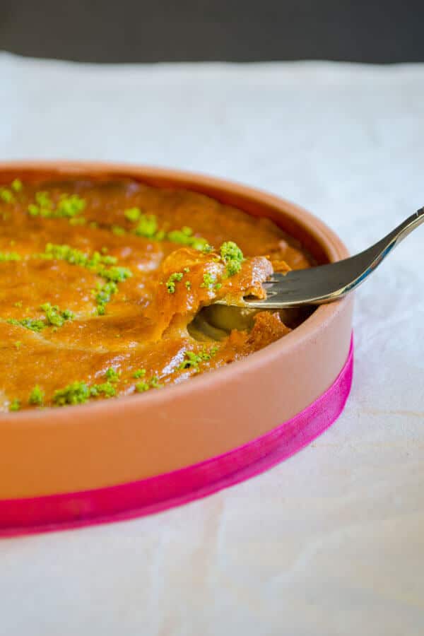 Sesame halva baked in oven and served on a clay plate.