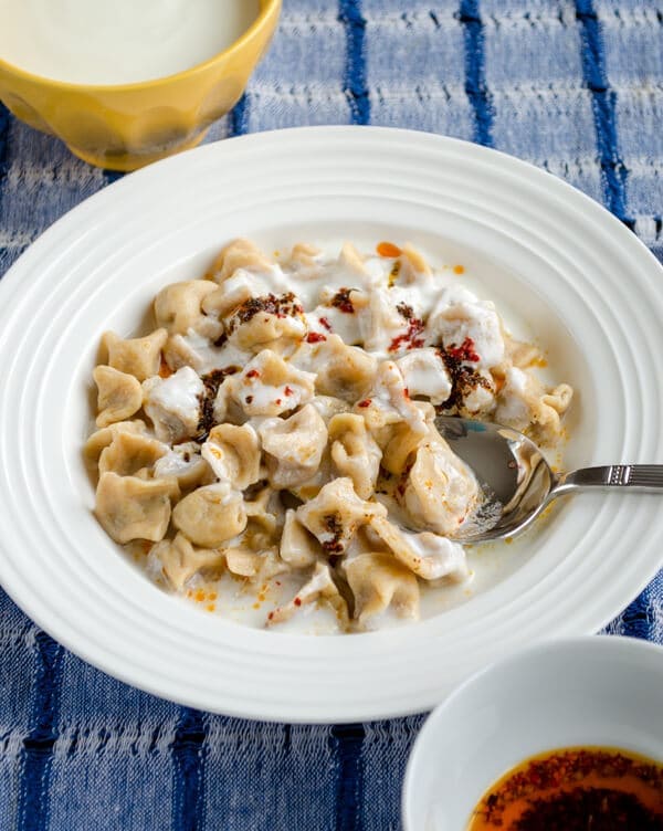 Turkish Dumplings Manti with yogurt in a white bowl