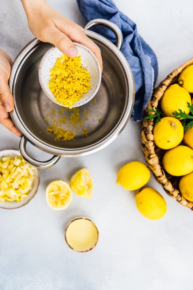 Woman making lemon jam in a pot