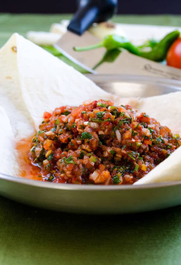 Ezme dip salad served on some lavash bread in a bowl.