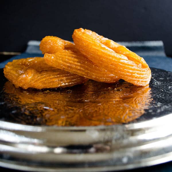 Three pieces of halka tatlisi on a metal plate.