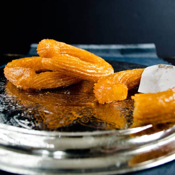 Turkish churros on a metal plate.