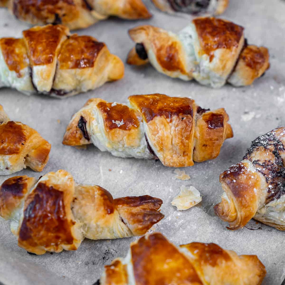 Puff pastry croissants on a baking sheet.
