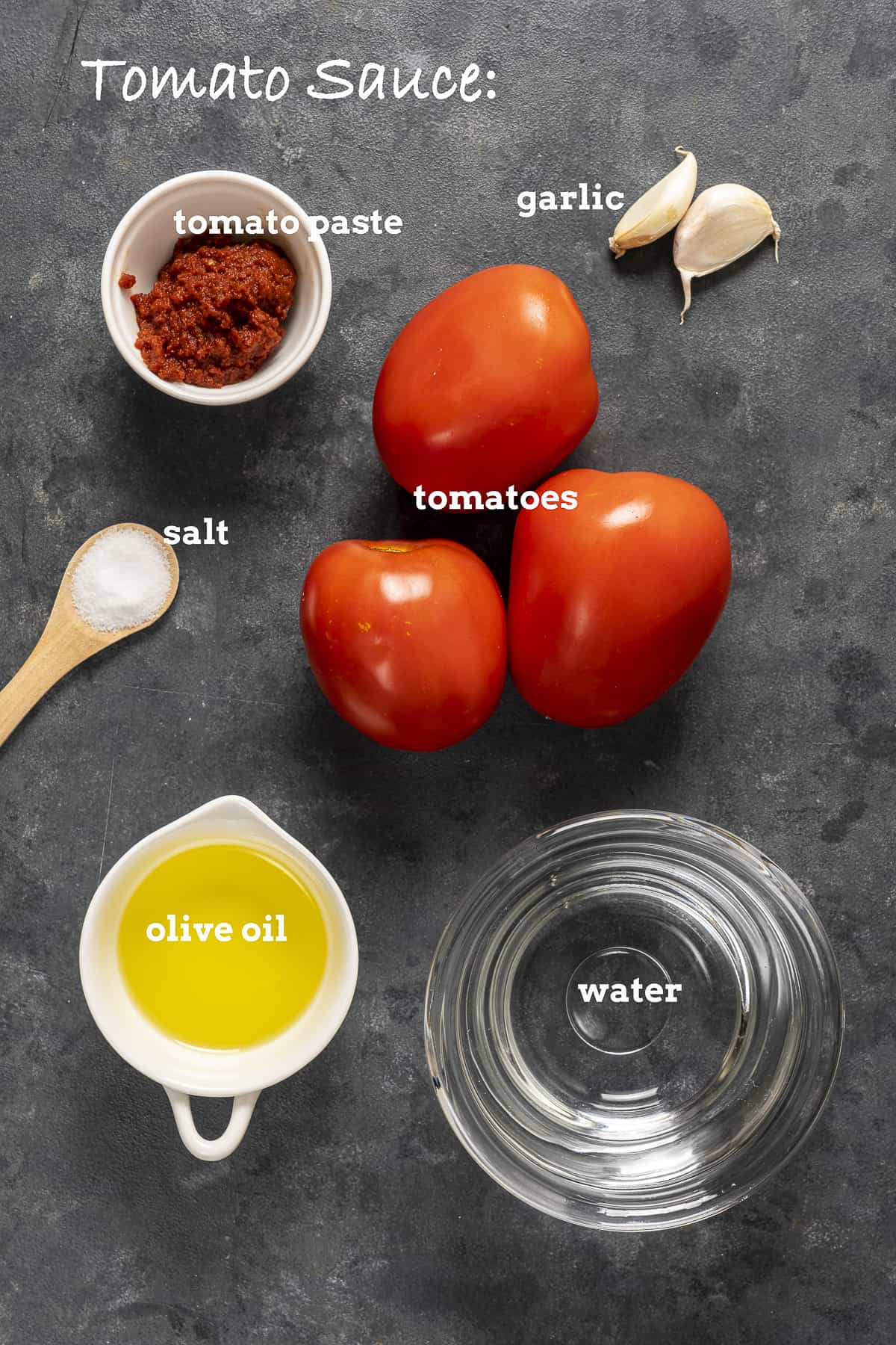 Tomatoes, tomato paste, garlic, olive oil, salt and water on a dark background.
