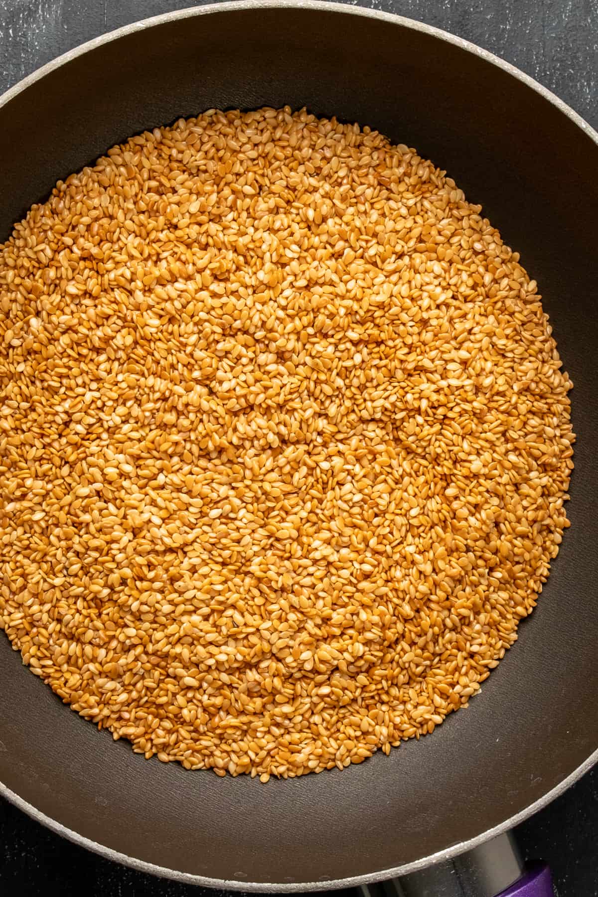Sesame seeds toasted in a non stick pan.