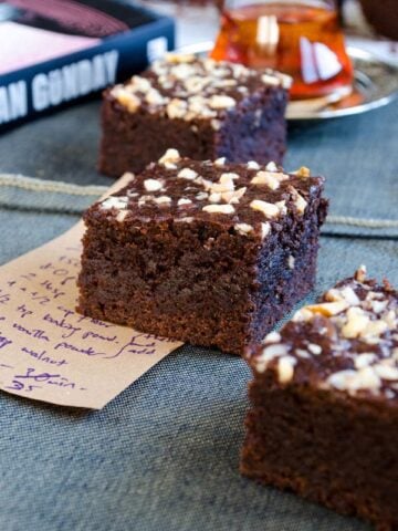 Chocolate apple brownies on a piece of paper with a recipe note