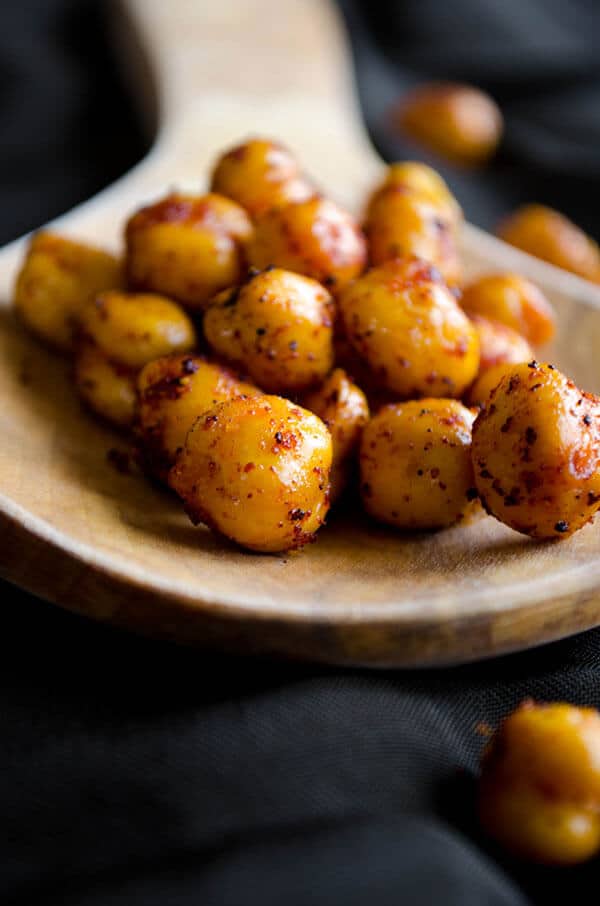 Crispy chickpeas on a wooden spoon.