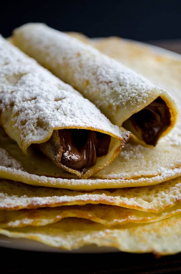 Wonderfully thin gluten free crepes made with rice flour are no different from regular crepes! So easy to make with only 4 simple ingredients. Perfect for several filling options! #glutenfreebreakfast #glutenfreecrepes #riceflourrecipes Nutella stuffed gluten free crepes