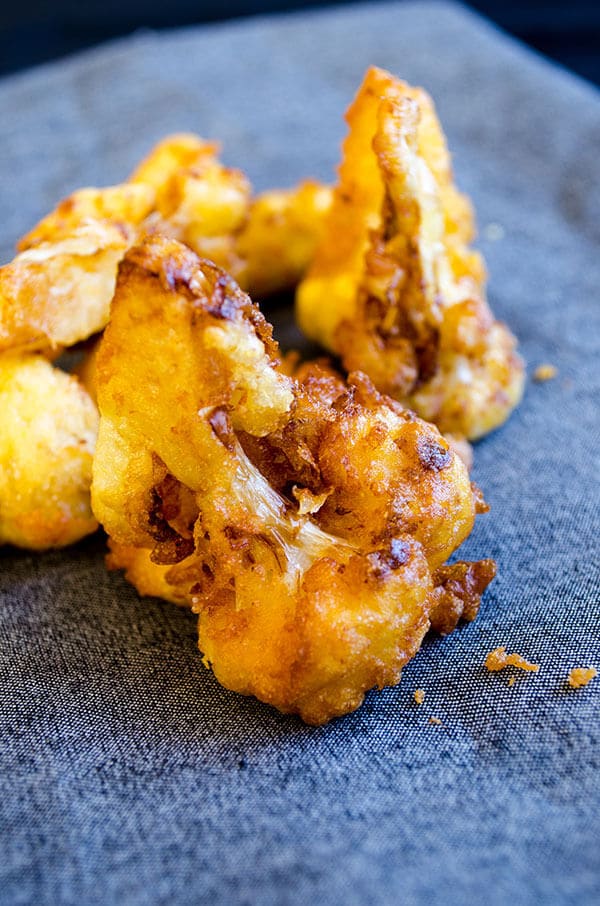 Fried cauliflower wings. Tender and crispy, these spicy battered cauliflower florets make perfect vegetarian snack. Gluten-free too. #cauliflowerrecipe #vegetarianrecipe #friedcauliflower How to fry cauliflower