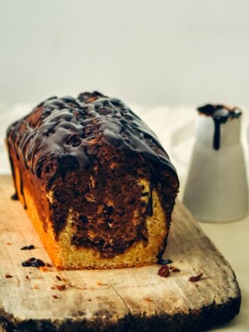 Marbled Chocolate Banana Bread topped with a silky chocolate ganache gives you the feeling of an amazingly light and moist chocolate cake. If you love chocolate and banana flavors together, you will LOVE this! Decadent and easy to make!