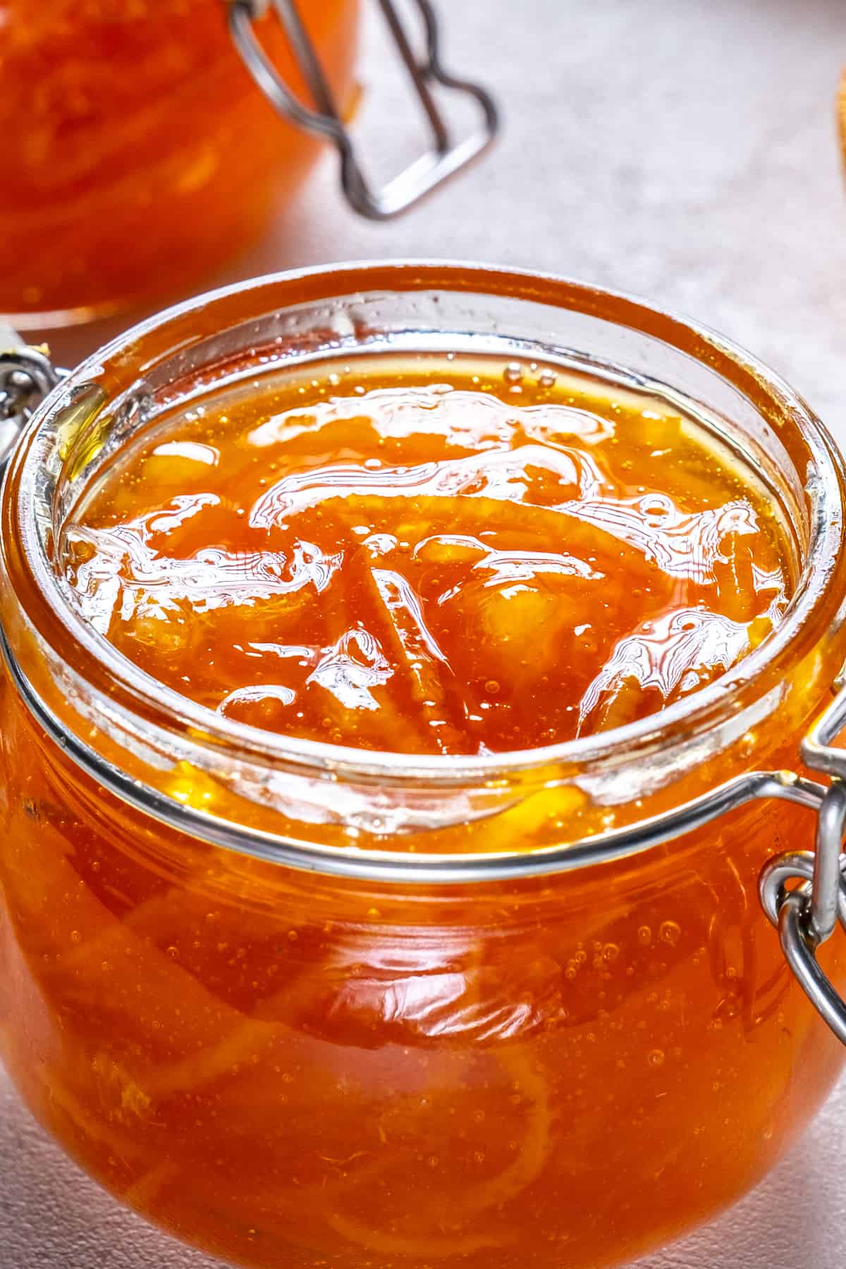 Orange jam in a glass jar.