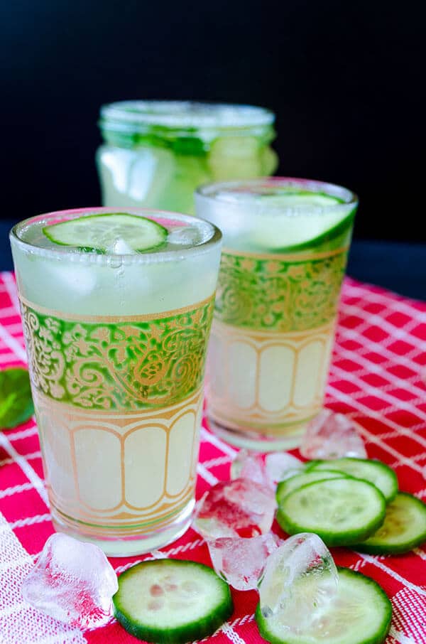 Cucumber lemonade recipe picture. Served in small glasses garnished with cucumber slices.