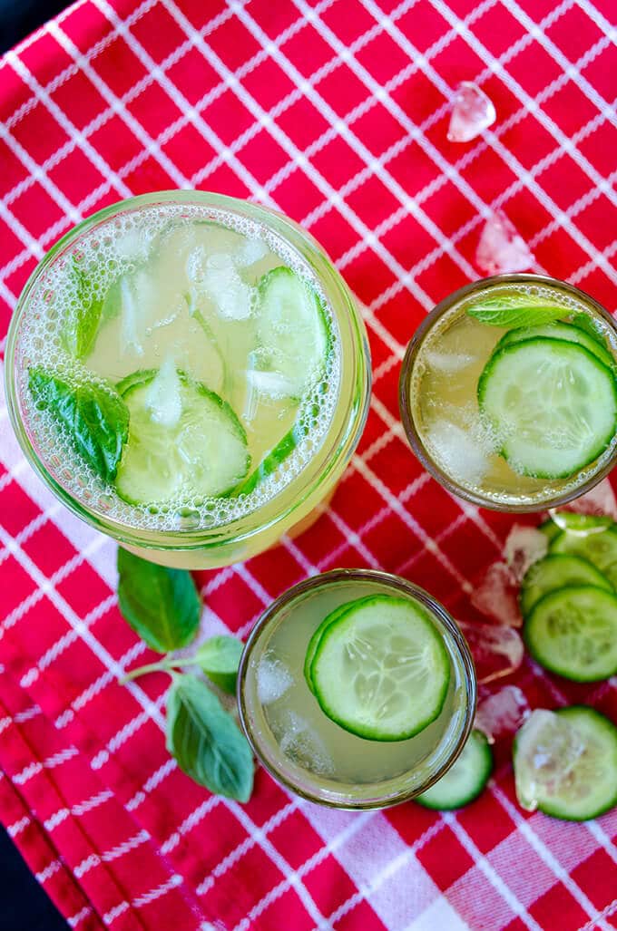 Nothing can beat the heat better than a big glass of delightful lemonade flavored with cucumber, lemon zest and fresh mint. Don’t forget to add lots of ice cubes into this incredibly Fresh Cucumber Mint Lemonade! #lemonade #cucumberlemonade #cucumbermintlemonade #cocktail Fresh cucumber mint lemonade in glasses