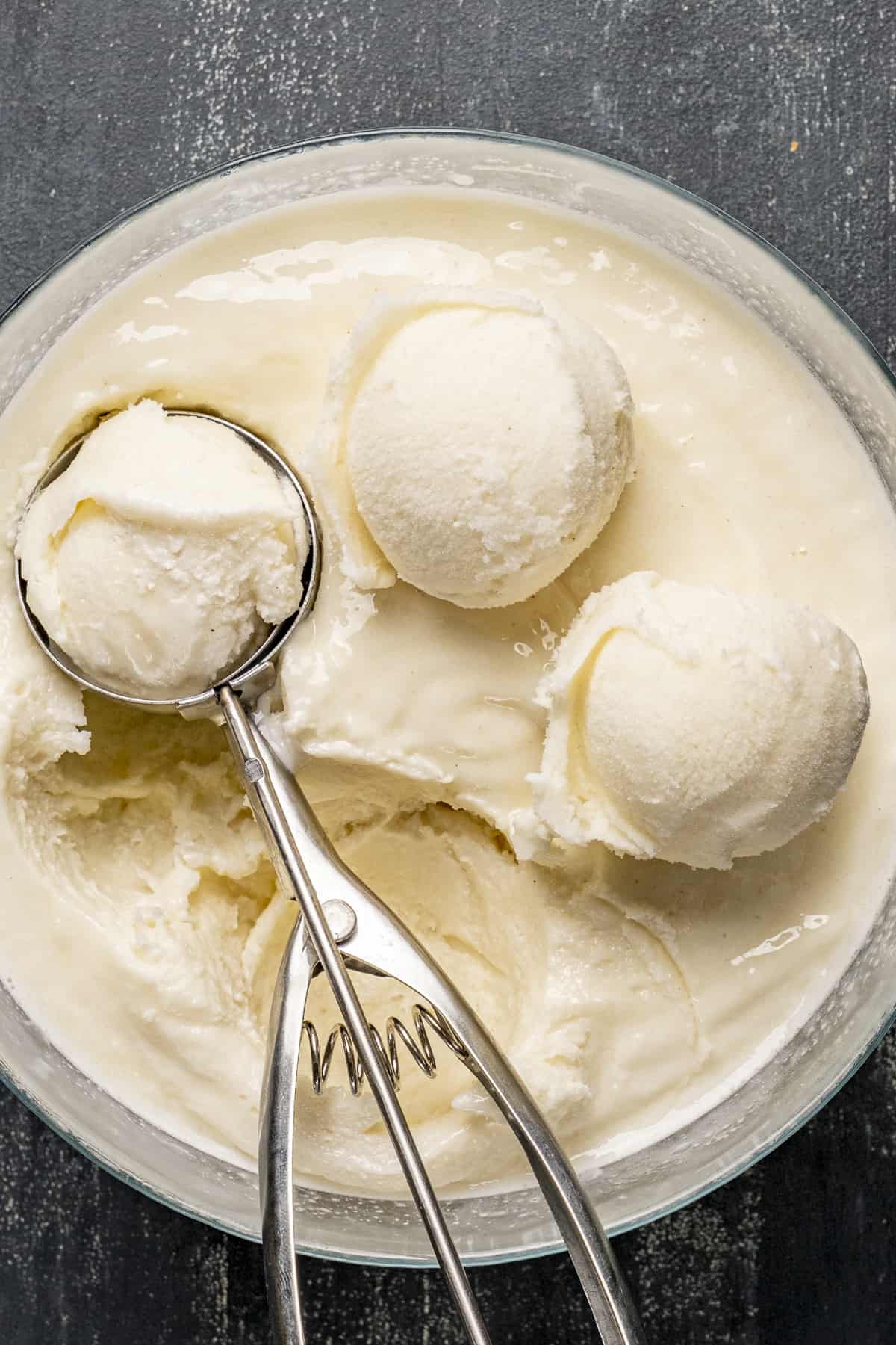 Ice cream in a large bowl, a scoop inside it.