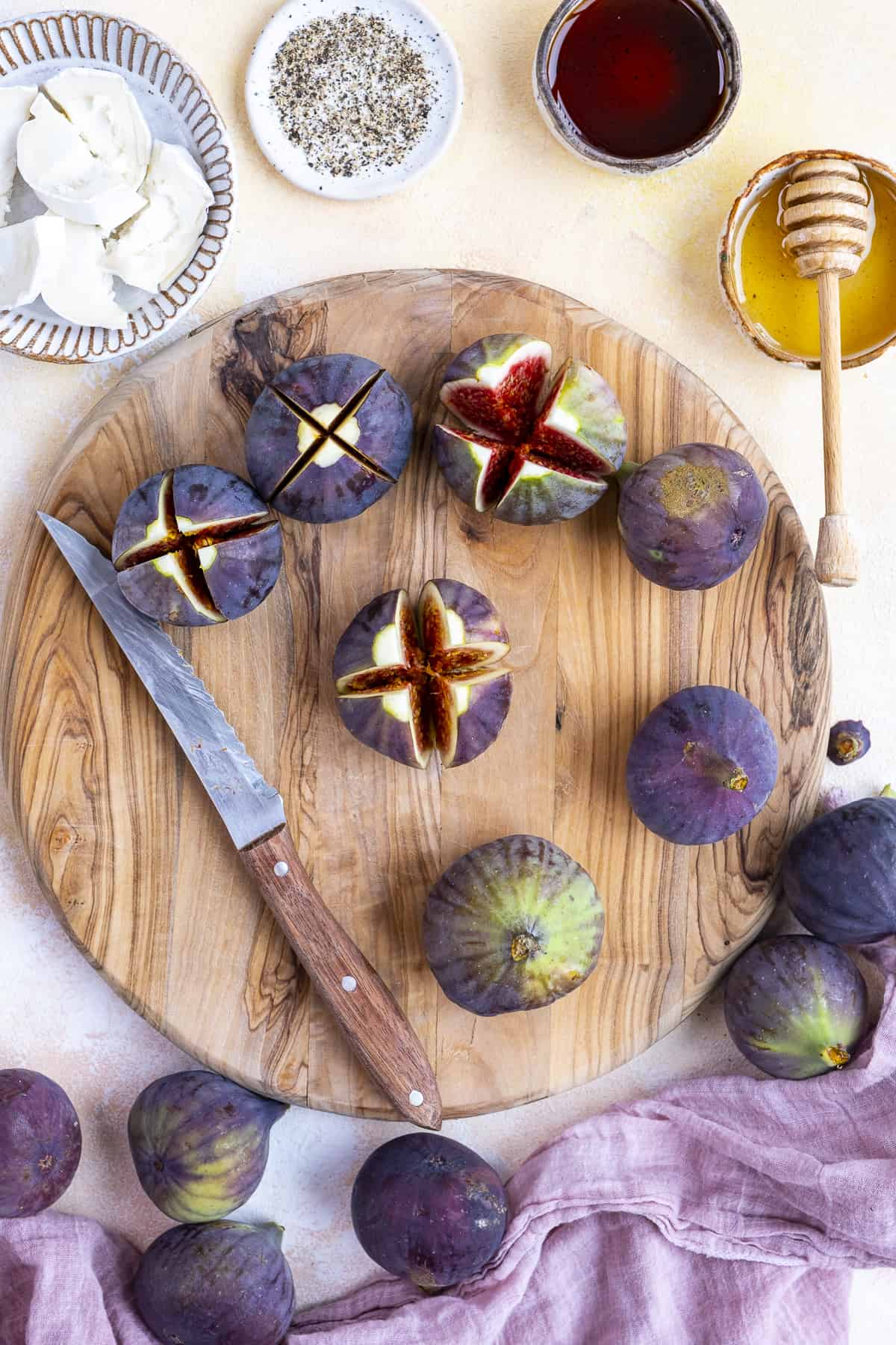 Figs are cut and prepared for stuffing with cheese.