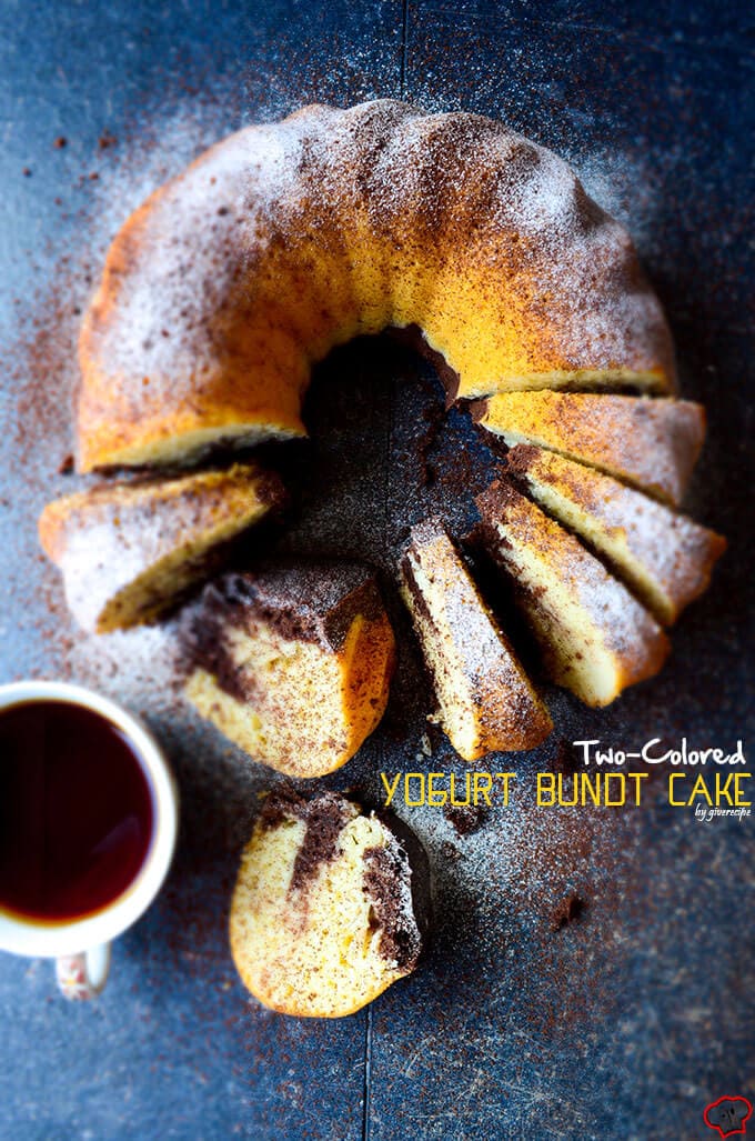 Marble yogurt bundt cake sliced on a dark backdrop