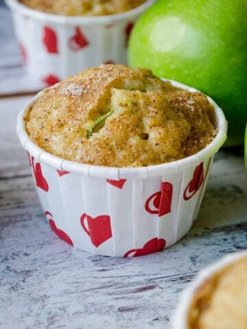 Zucchini Cinnamon Apple Muffins in muffin liners with heart shapes