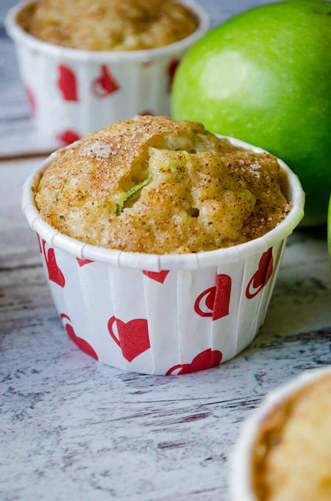 Zucchini Apple Cinnamon Muffins with cinnamon sugar topping. Wonderfully moist thanks to zucchini, applesauce, grated apple and yogurt. Perfect on the go breakfast in fall! #zucchinirecipes #applecinnamonmuffins #fallbaking #zucchinimuffins Zucchini Cinnamon Apple Muffins in muffin liners with heart shapes