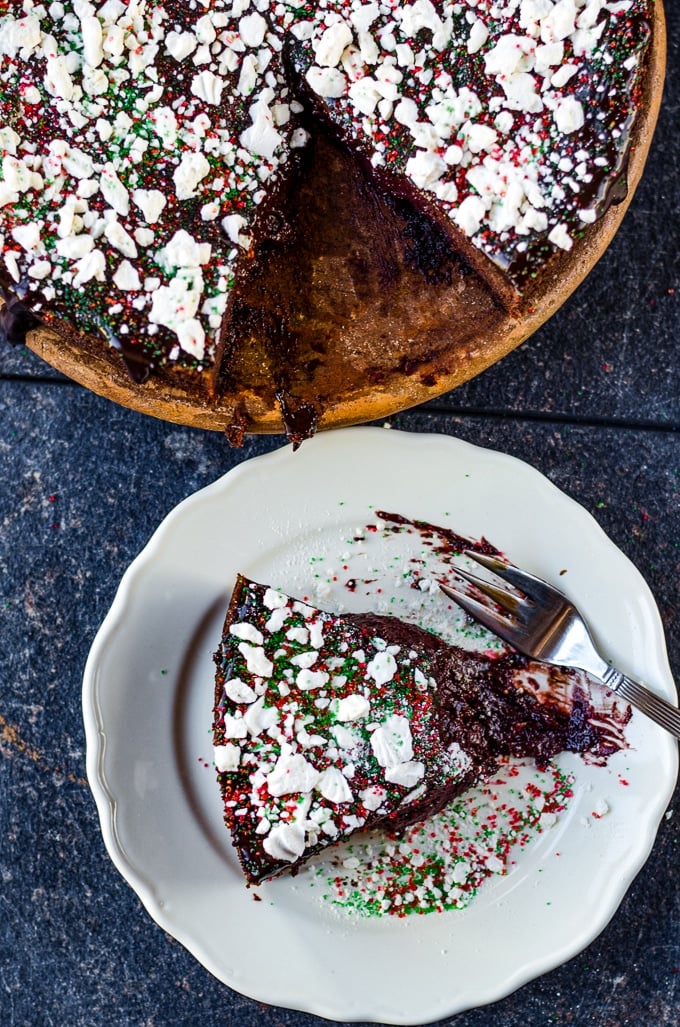 Sliced chocolate beet cake on a white plate with a fork on the side.