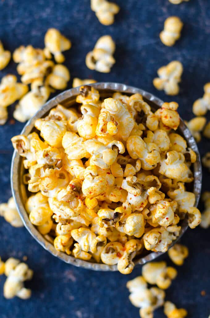 Homemade stovetop popcorn seasoned with chili powder, black pepper and cumin. #spicypopcorn #homemadepopcorn #howtomakepopcorn Salty Spicy Popcorn in a copper bowl