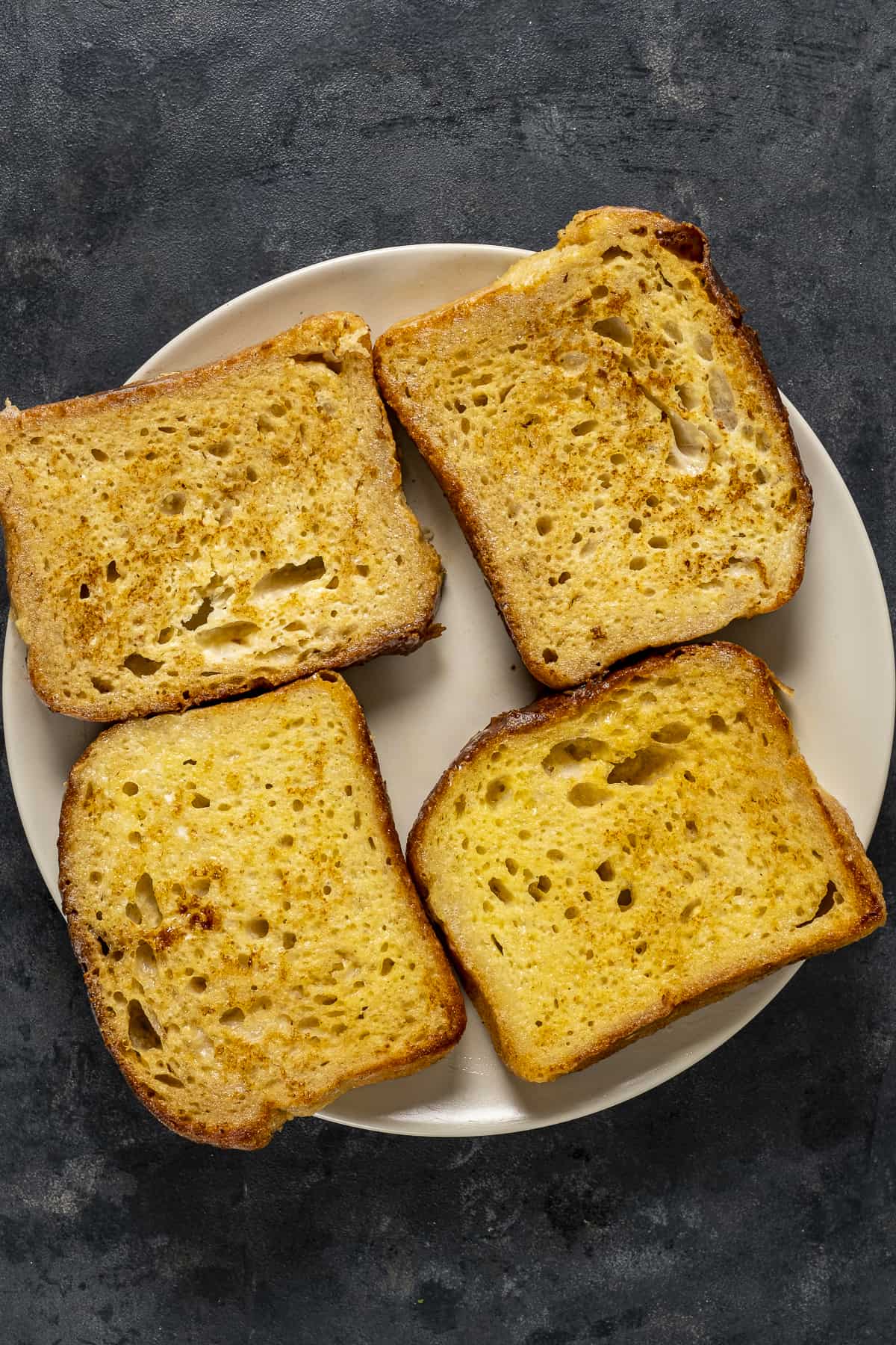 Four French toast bread slices on a plate.