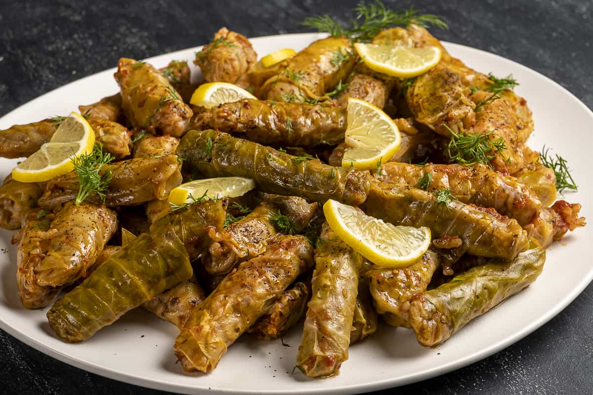 Cabbage rolls on a white plate.