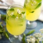 Ginger lemonade garnished with blossoms in two glasses