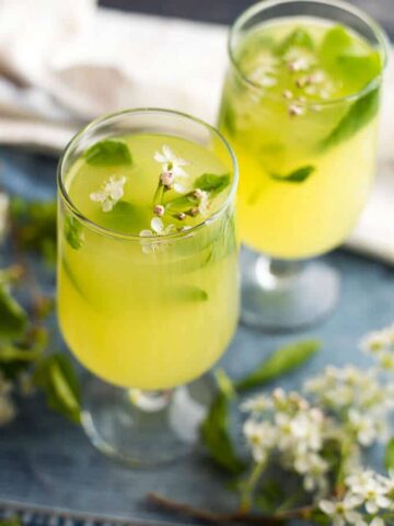 Ginger lemonade garnished with blossoms in two glasses